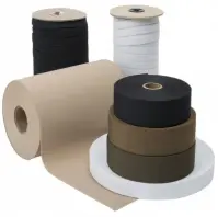 Multiple rolls of flat elastic stacked and next to each other in the colors of black, white, beige, and dark green