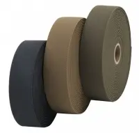 Three rolls of flat woven elastic in the colors of black, dark green, and light brown